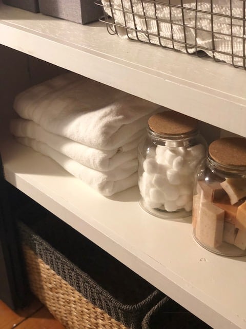 Cotton balls in jars as well as soap on the shelves in the closet.