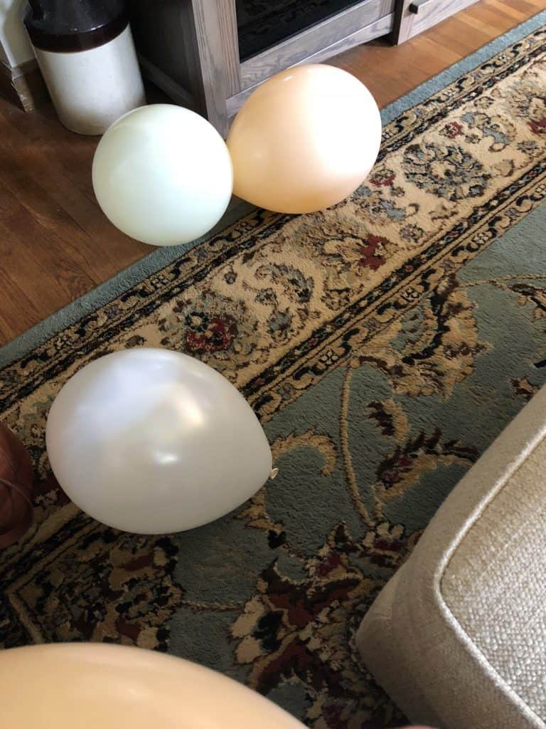 Blown up balloons on the floor.