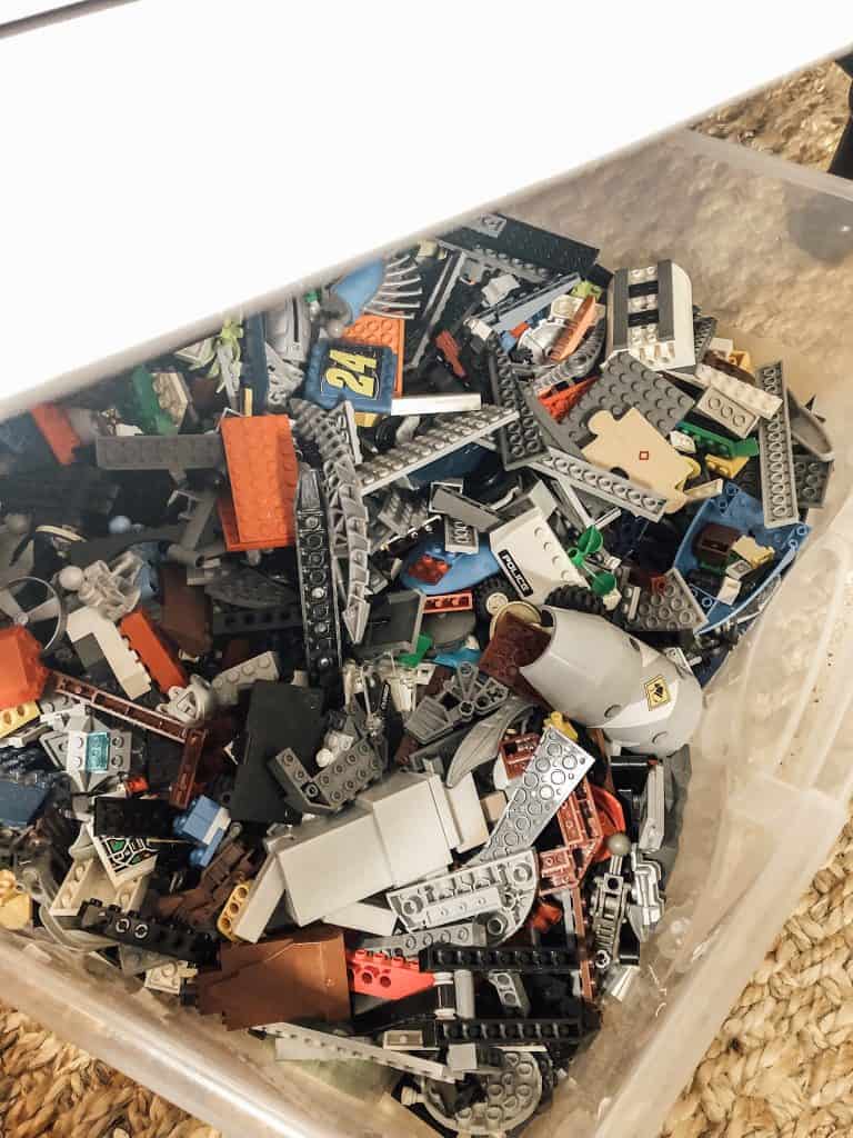 A plastic bin filled with lego.