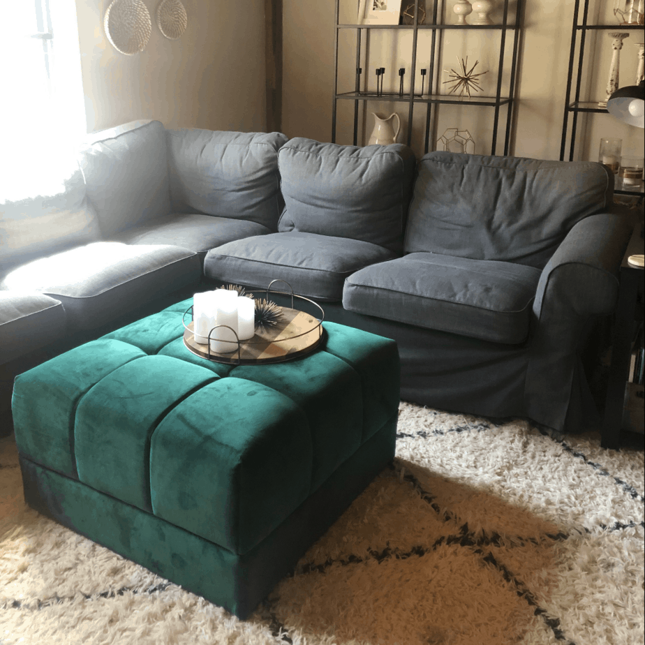 Gray Ikea sectional couch that is worn.