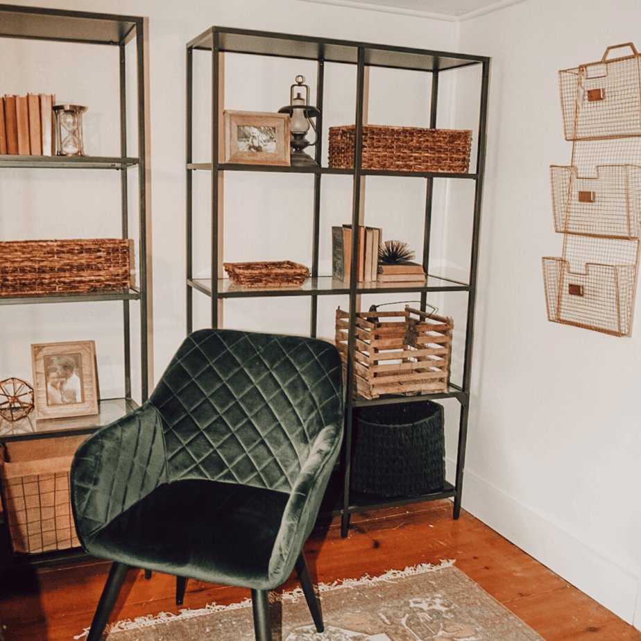 green office chair and black book cases with brown baskets