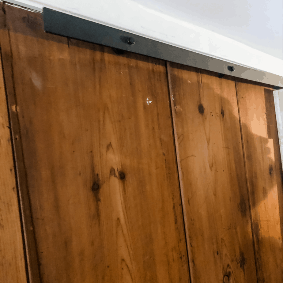 Wood wall panels and metal bracket for door hardware.