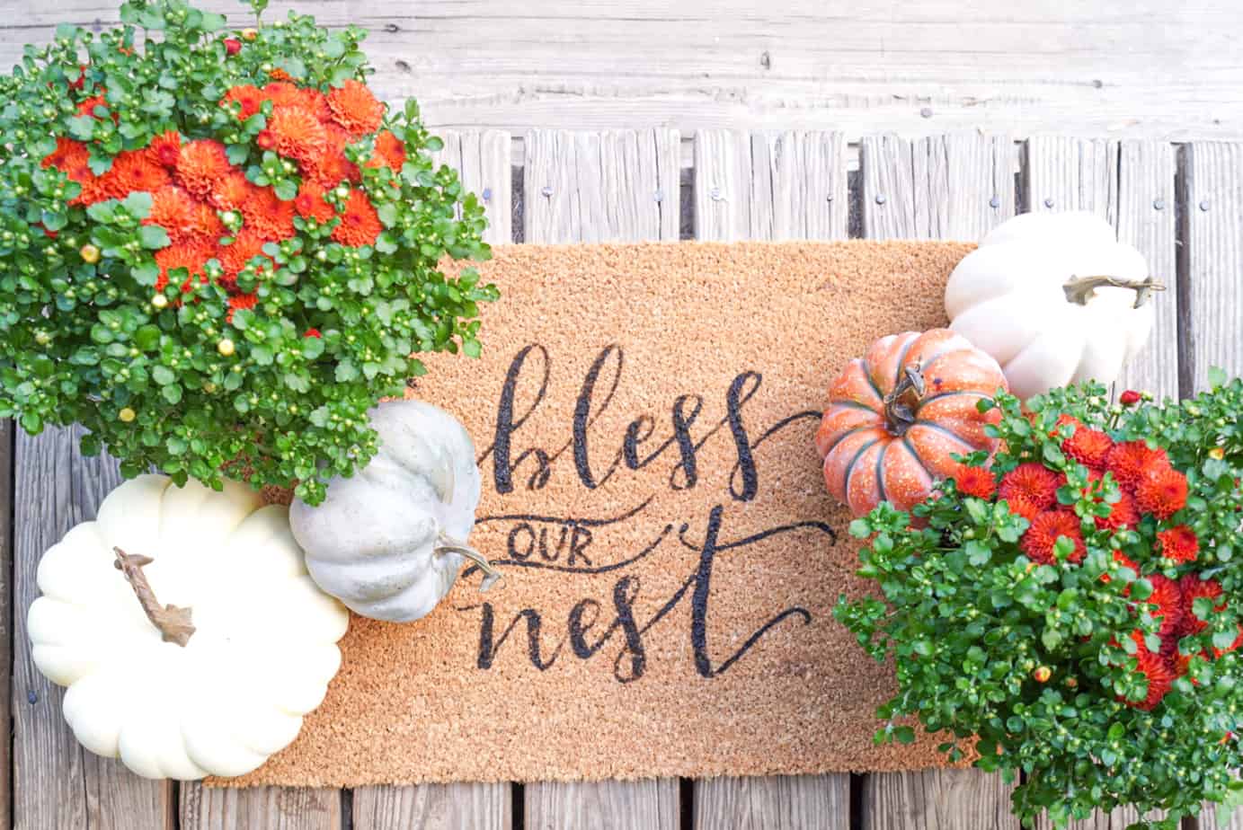 welcome mat that says bless this nest with pumpkins 