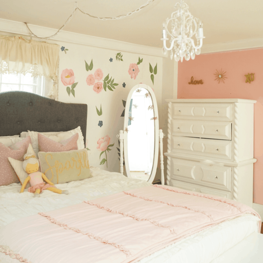 white bedding with coeval mirror and pink wall with flowers