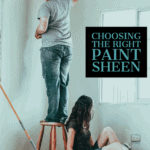 man on latter painting with woman on the floor