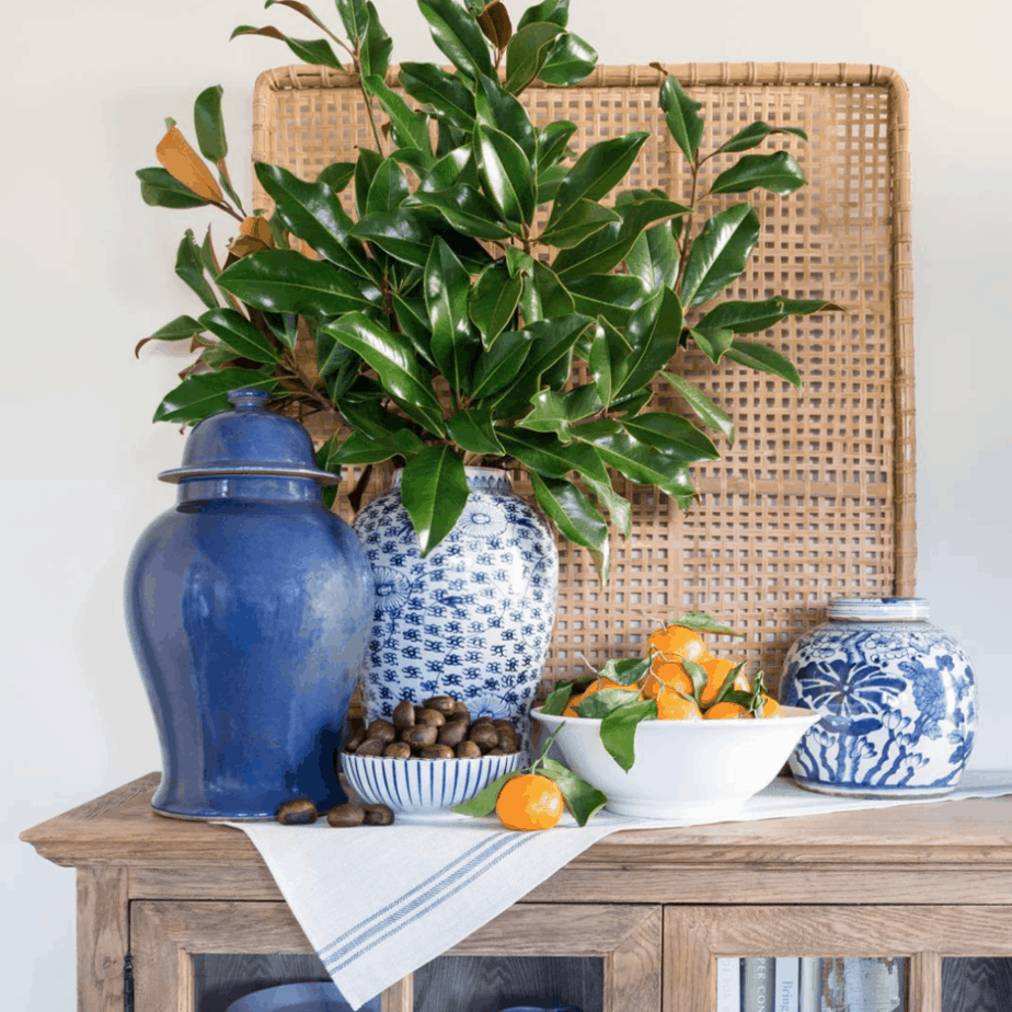 large woven basket over table with plant and jars on table