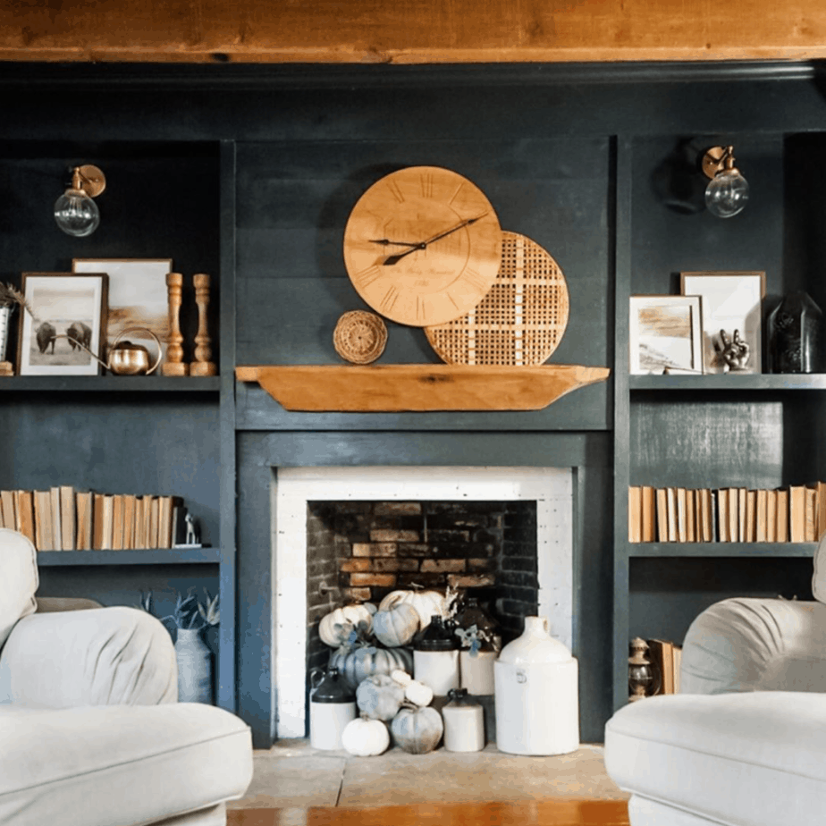 blue fireplace surround with a wooden clock on mantel