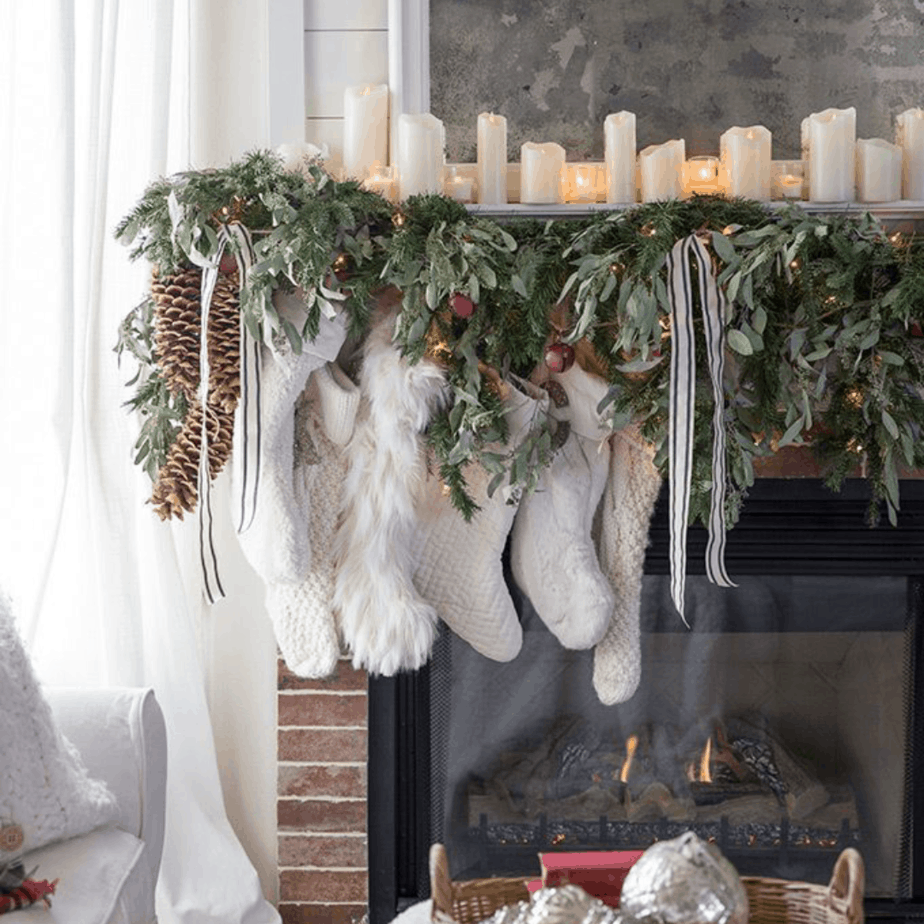 white stocking on fireplace with flameless candles