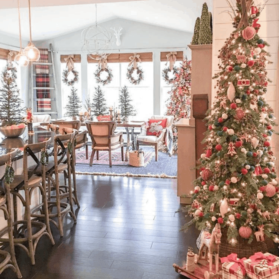 Christmas tree and wreaths in dining room hung with ticking ribbon
