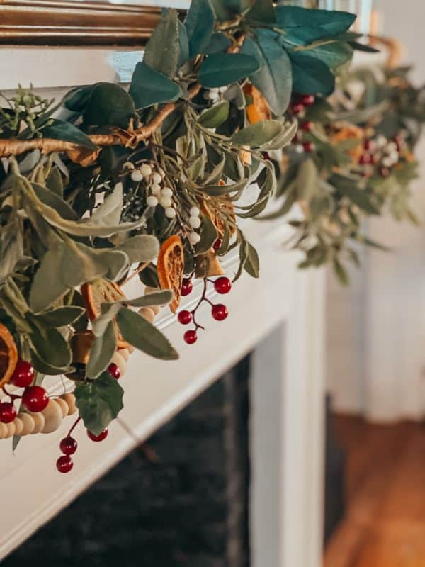 Christmas garland over mantel with berries and dried oranges.