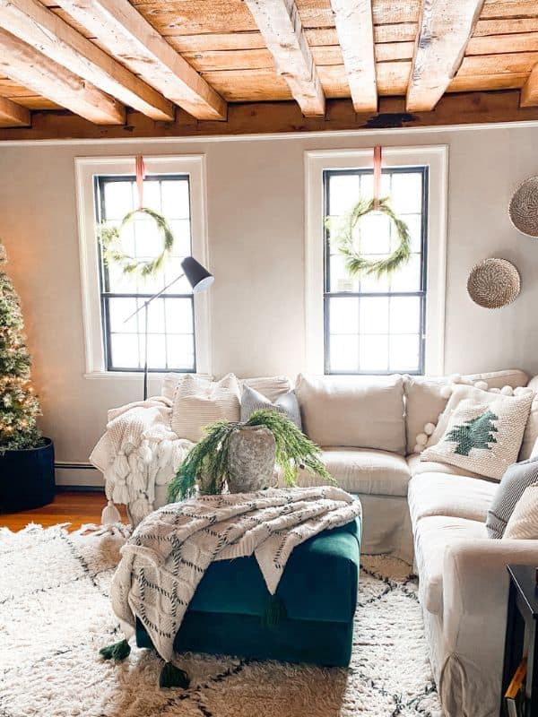 fFresh wreaths over windows in living room. 