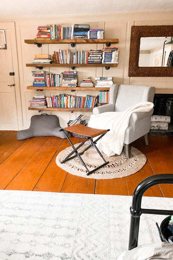 gray arm chair, foot stool, book shelf