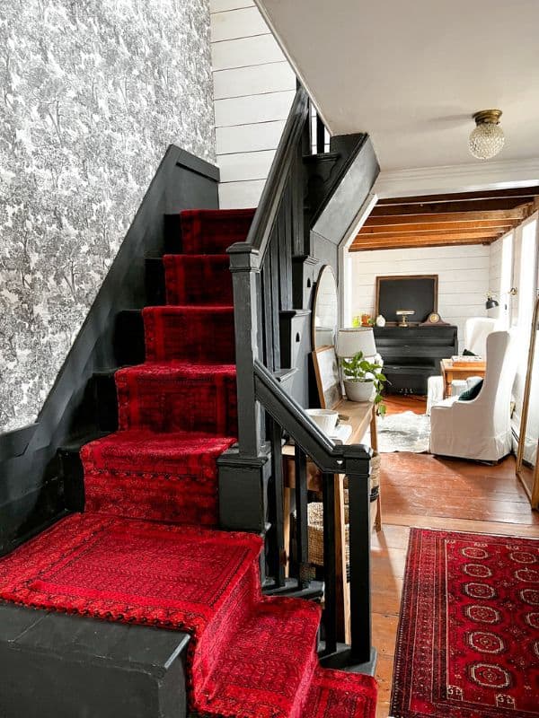 Red carpet runner installed on clack staircase. 