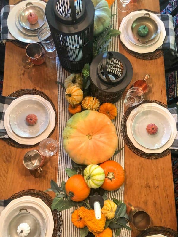 Fall centerpiece with pumpkins and gourds.