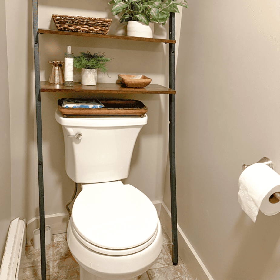 New white toilet with a shelf over toilet.