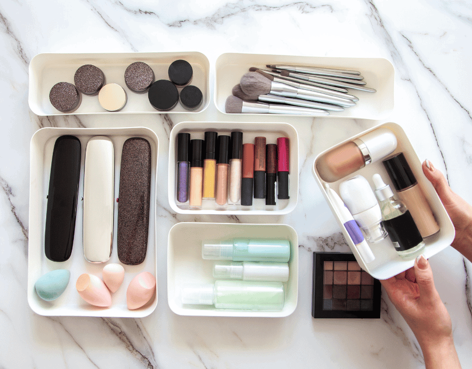 Makeup organized in small white baskets